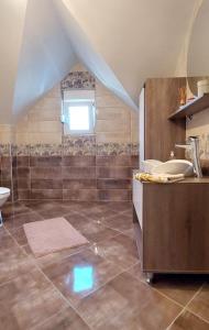 an attic bathroom with a sink and a tub at Sunny in Trnava