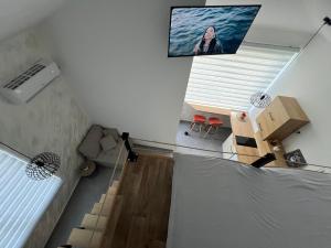 a room with a bed and a tv on the ceiling at Apartmani Vivami in Budva