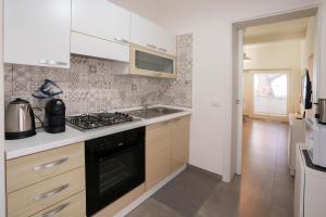 a kitchen with a sink and a stove top oven at Seaview in Torre Grande +12 photos