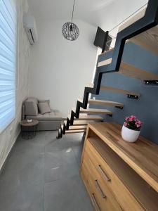 a staircase in a living room with a couch at Apartmani Vivami in Budva