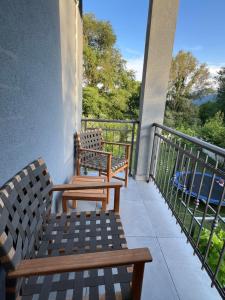 two benches sitting on the balcony of a building at Apartmani Vivami in Budva
