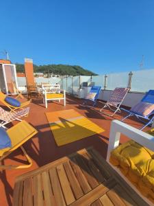 a deck with chairs and tables on a ship at House Moledo sea view in Moledo