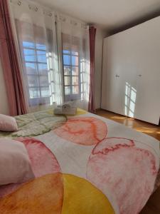 a bedroom with a large bed with a colorful blanket at House Moledo sea view in Moledo