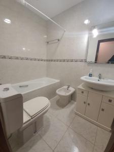 a white bathroom with a toilet and a sink at House Moledo sea view in Moledo +21 photos