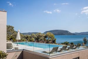a swimming pool on a building with a view of the water at Presidential Beach Villa in Alyfantá