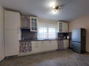 a kitchen with white cabinets and a refrigerator at Sunny in Trnava +46 photos