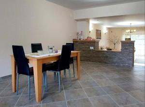 a dining room with a wooden table and black chairs at Sunny in Trnava