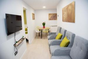 a living room with a couch and a table at Pregonero Urban Suites - Verde in Soria