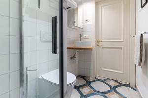 a bathroom with a toilet and a glass shower at Appartamenti VERDE ACQUA in Pergine Valsugana +23 photos