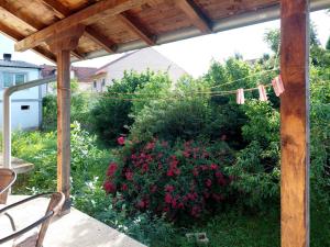a patio with a garden with pink flowers at Sunny in Trnava