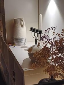 a counter with a vase and a candle and a plant at Maravillosa casa con vistas al mar in Baiona +41 photos