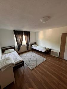 a bedroom with two beds and a window at Wohnungen bei Post in Hünfelden