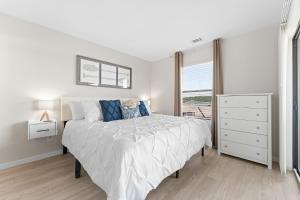 a white bedroom with a bed and a window at Oasis on Table Rock Lake in Kimberling City +15 photos