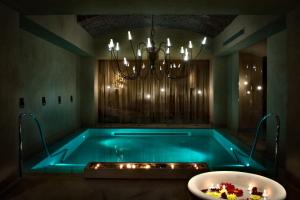 a bath room with a tub and a bath tub tub at Château Monfort - Relais & Châteaux in Milan