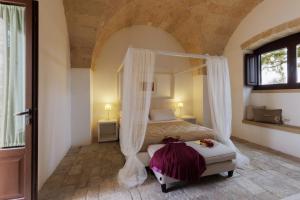Postel nebo postele na pokoji v ubytování Masseria Corda Di Lana Hotel & Resort