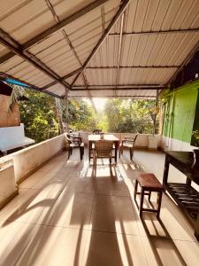 a patio with a table and chairs on a roof at Santa Maria Hostel Kovalam in Kovalam +76 photos