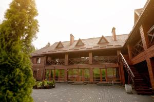 a large wooden building with a metal roof at Chalet Filvarok in Slavske