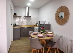 a dining room with a table and chairs in a kitchen at LA CASA DE VIOLETA in Suances