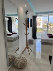 a room with two beds and a mirror at Tenerife Sea View Sun Beach Apartment 222 in Playa Fañabe +57 photos