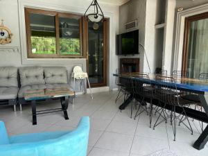 a living room with a table and a couch at Villa Onuk in Sapanca