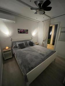 a bedroom with a bed and a ceiling fan at Apartments PUPA in Povljana