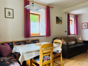 a living room with a table and a couch at Apartments Bernard in Aldino