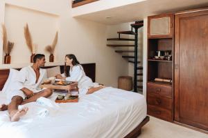 Кровать или кровати в номере Mezzanine Tulum, a Small Luxury Hotel