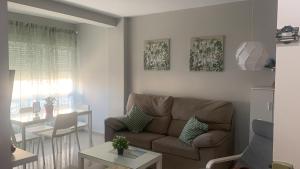 a living room with a couch and a table at Apartamento CENTRO in Mazagón