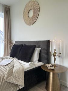 a bedroom with a bed with a table and a mirror at Rami Jūra 2022 in Šventoji