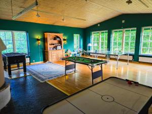 a living room with a ping pong table and a ping pong table at Åsljungagården in Åsljunga