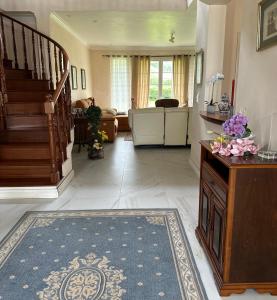 a living room with a staircase and a rug at Quinta do Sossego in Pico da Pedra