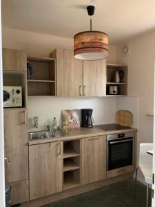 a kitchen with wooden cabinets and a sink at Nett in Mettmann in Mettmann