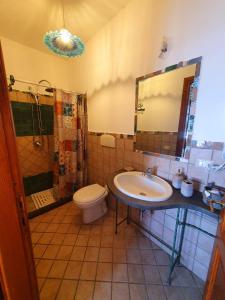 a bathroom with a sink and a toilet and a mirror at Sinis Apartment in Palmas Arborea +26 photos