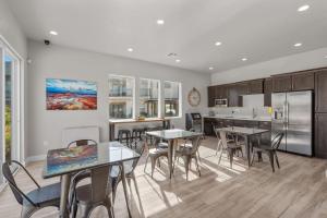 a kitchen with tables and chairs and a refrigerator at Ocotillo Springs Resort 41 Private Hot Tub, Nintendo Console, BBQ Grill & Beautiful Resort Pool in Santa Clara