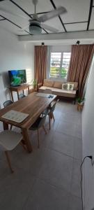 a living room with a wooden table and a couch at Dpto Temporario La Rosada in Corrientes