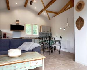 a living room with a blue couch and a table at La petite maison des écureuils in Mios