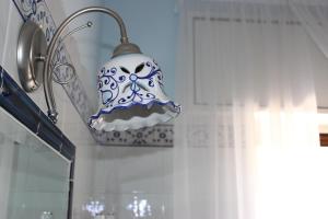 a blue and white lamp hanging from a wall at Casa Blu Cobalto in Maiori
