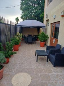 a patio with a table and chairs and an umbrella at Studio Aurora Blue in Eforie Sud