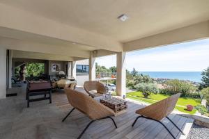 a living room with chairs and a view of the ocean at st clair villa 2 piscines in Sète
