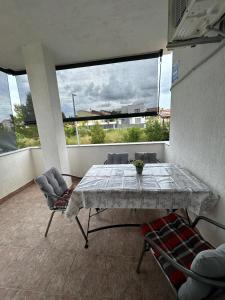 a table and chairs in a room with a large window at Apartments Marina in Posedarje