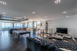 a living room with couches and a pool table at st clair villa 2 piscines in Sète