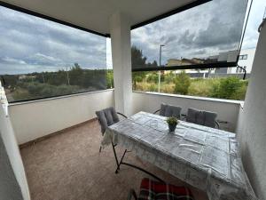 a balcony with a table and chairs on a balcony at Apartments Marina in Posedarje