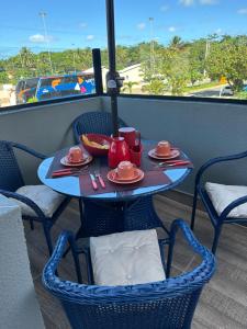 a table with plates of food on a balcony at Villas do Porto APTO 05 - Porto de Galinha in Porto De Galinhas