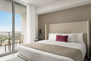 a bedroom with a large bed and a large window at Hyde Beach by Zelloo in Hollywood +8 photos