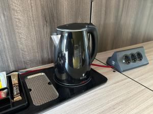 a coffee maker sitting on top of a table at Villa Yemaya - camera con bagno privato in Casarsa della Delizia