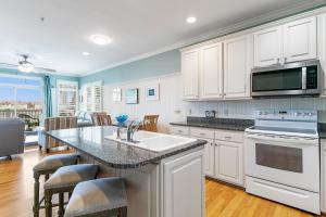 a kitchen with white cabinets and a counter top at 16 Turtle Bay Riverview Pool in Folly Beach