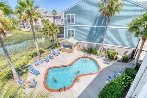 an overhead view of a swimming pool in front of a house at 16 Turtle Bay Riverview Pool in Folly Beach