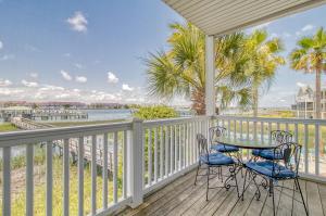 a balcony with a table and chairs and a view of the water at 16 Turtle Bay Riverview Pool in Folly Beach