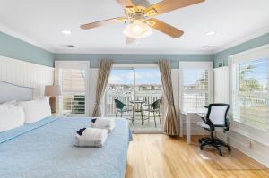 a bedroom with a bed and a ceiling fan at 16 Turtle Bay Riverview Pool in Folly Beach +33 photos