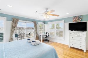a bedroom with a bed and a flat screen tv at 16 Turtle Bay Riverview Pool in Folly Beach
